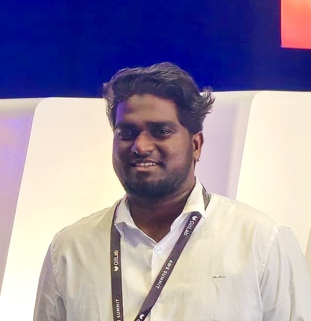 Thirumalai Arumugam at a technology event with lanyard